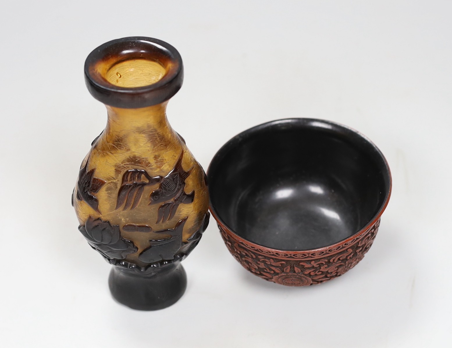 A Chinese red lacquer bowl and a Chinese overlaid glass vase, 17cm